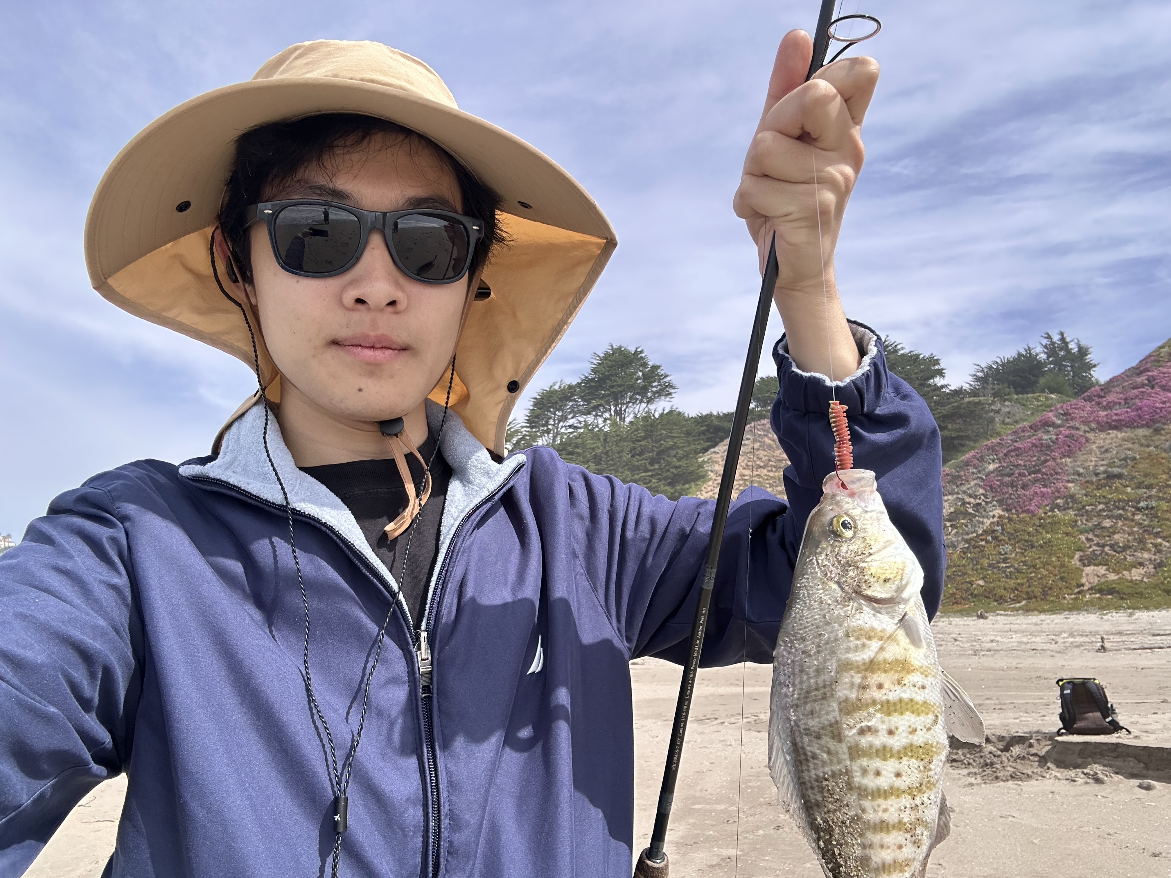 A fishing rod beside a quiet lake