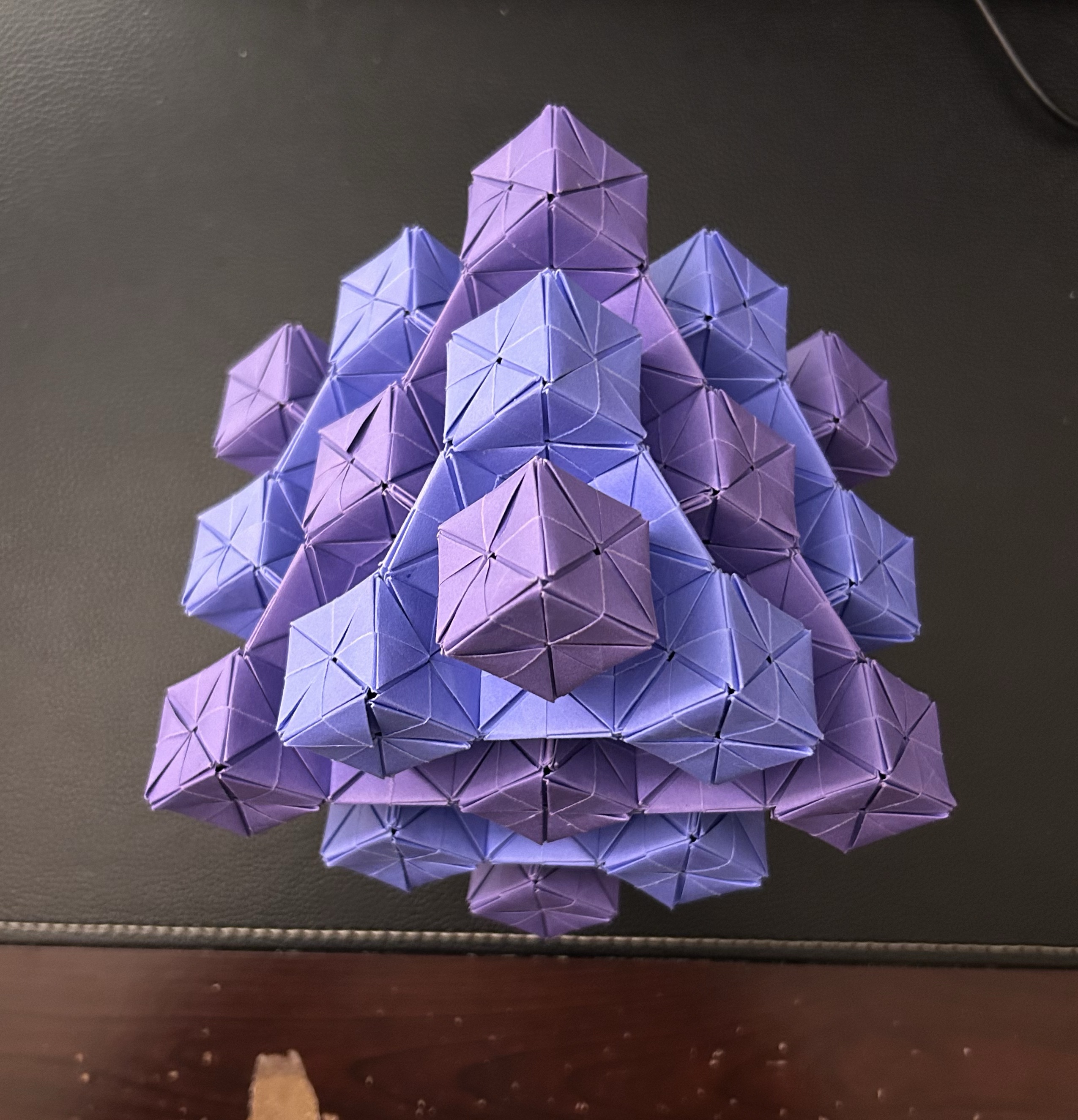 A blue origami crane on a tabletop