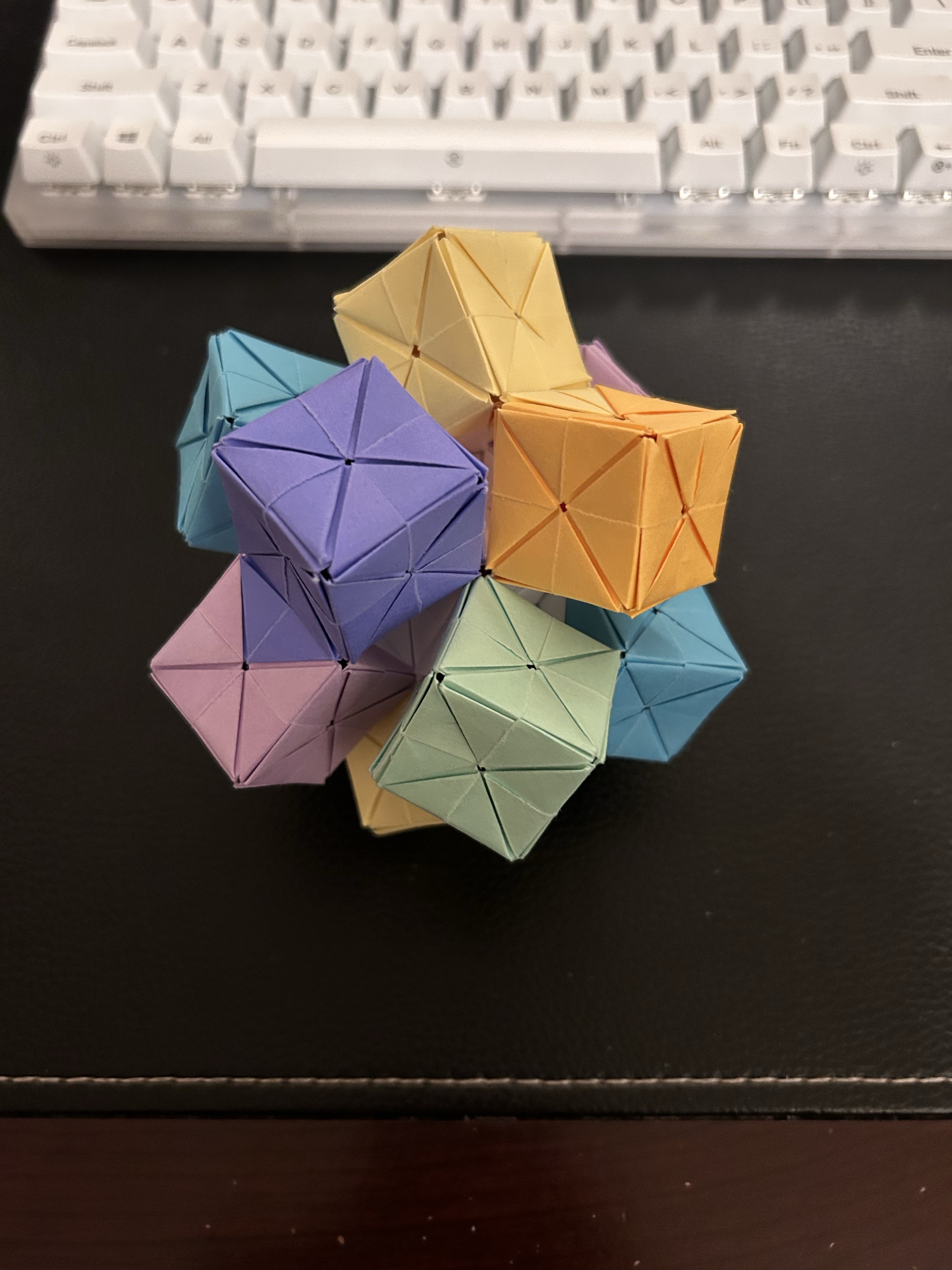 A blue origami crane on a tabletop